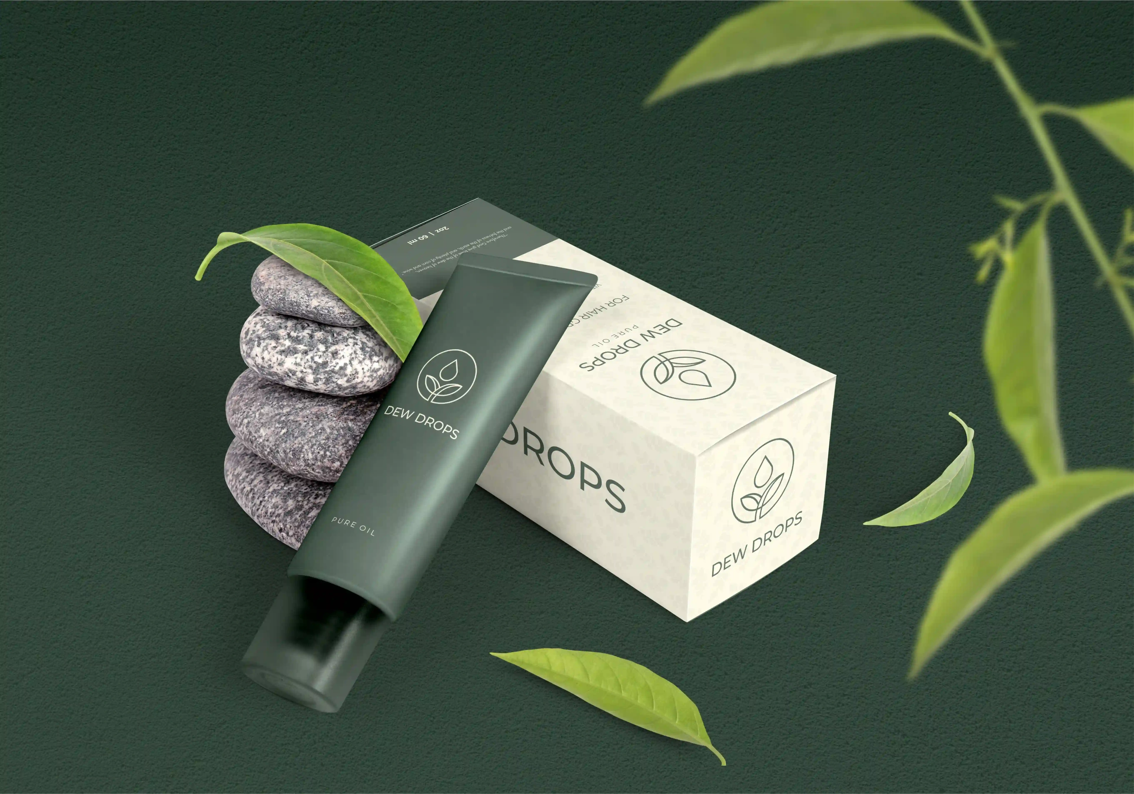 Dew Drops green tube and carton with balanced stones and fresh leaves