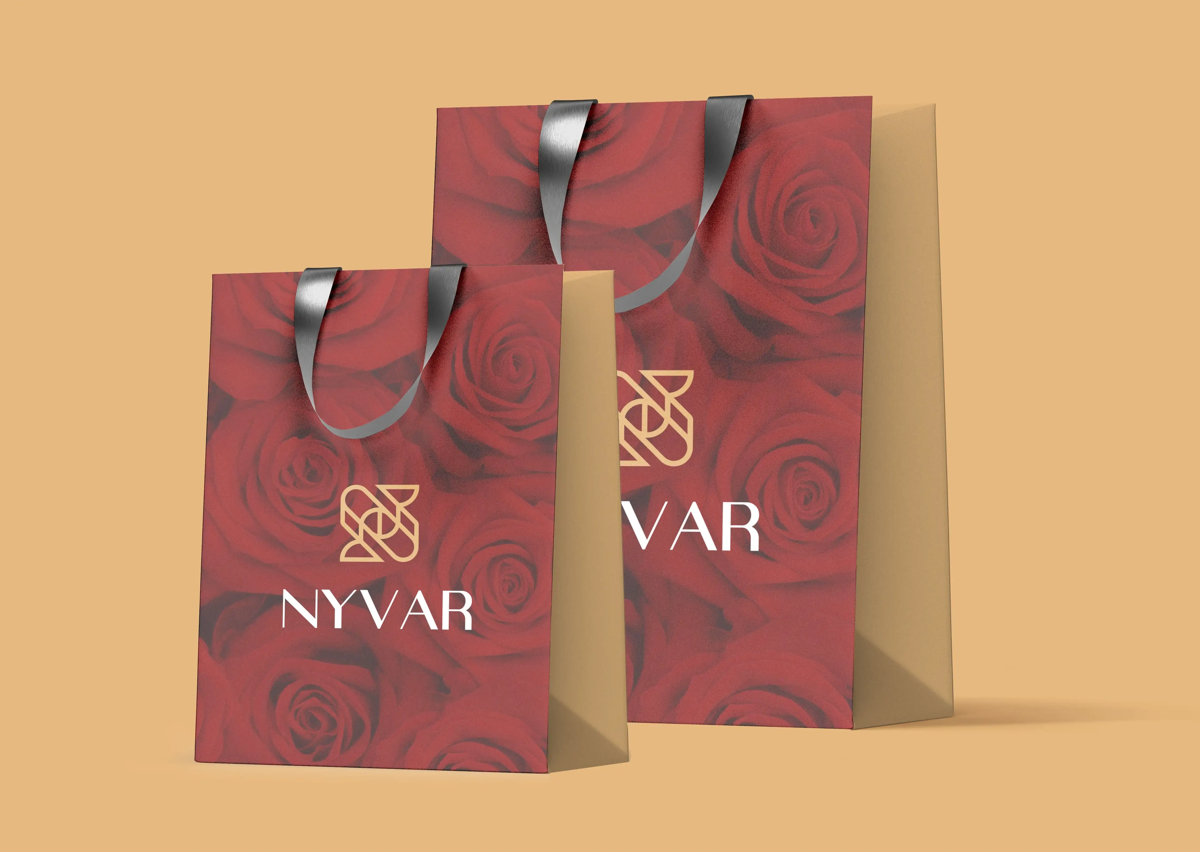 Nyvar red rose-print paper shopping bags with ribbon handles on a warm gold background
