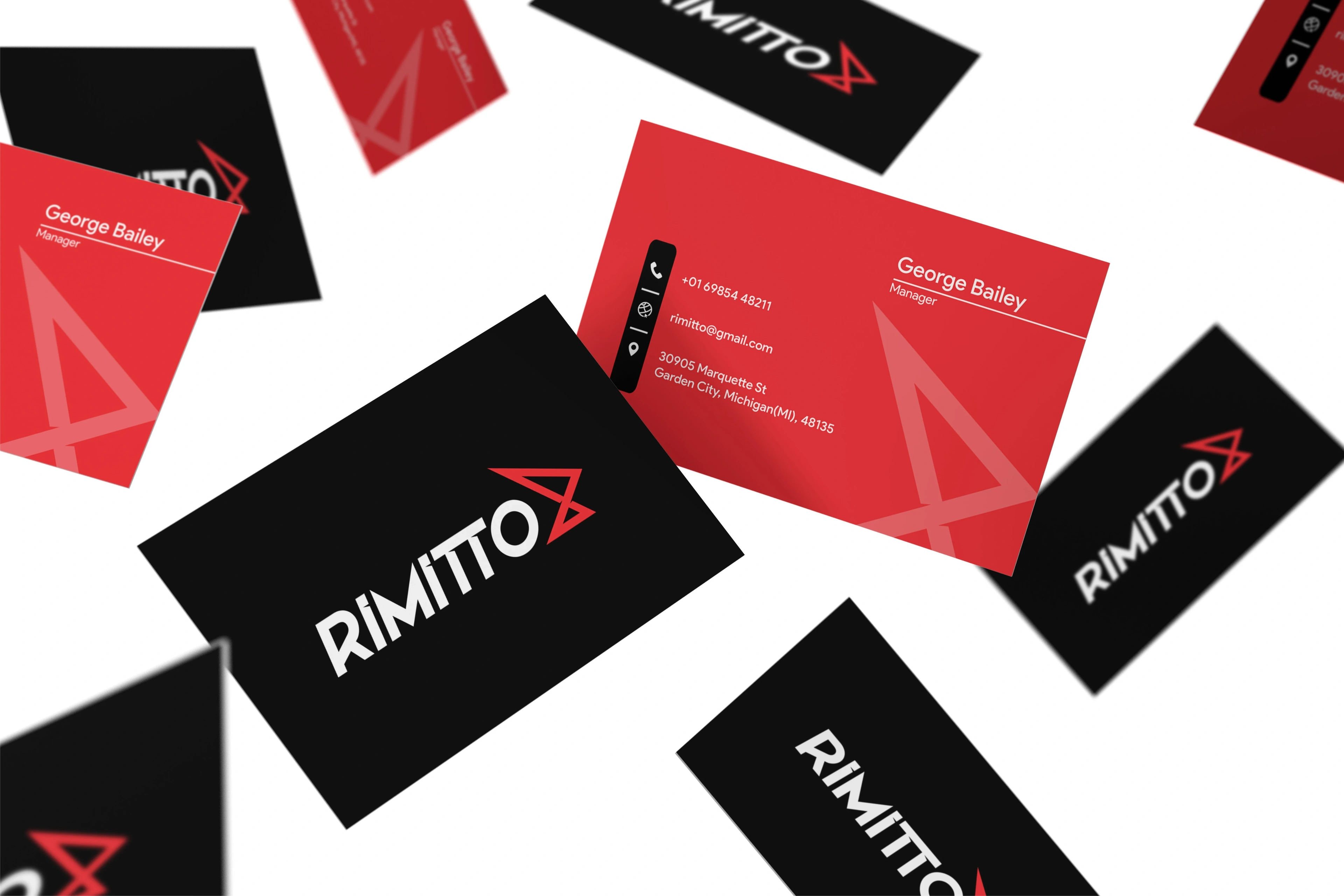 Rimitto business cards in black, red and white scattered on a white background