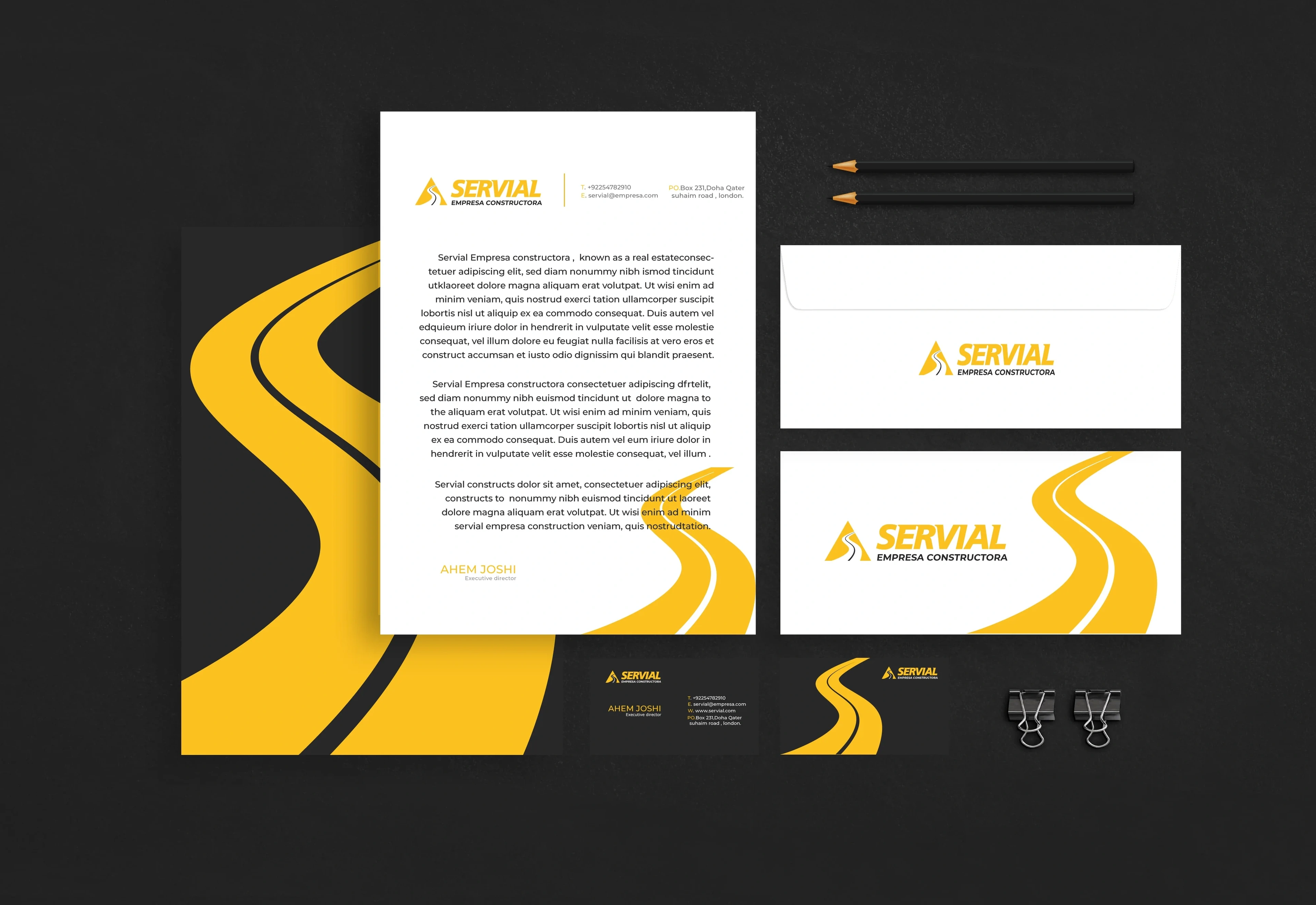 Servial stationery: letterhead, envelopes and cards with a yellow road graphic on charcoal