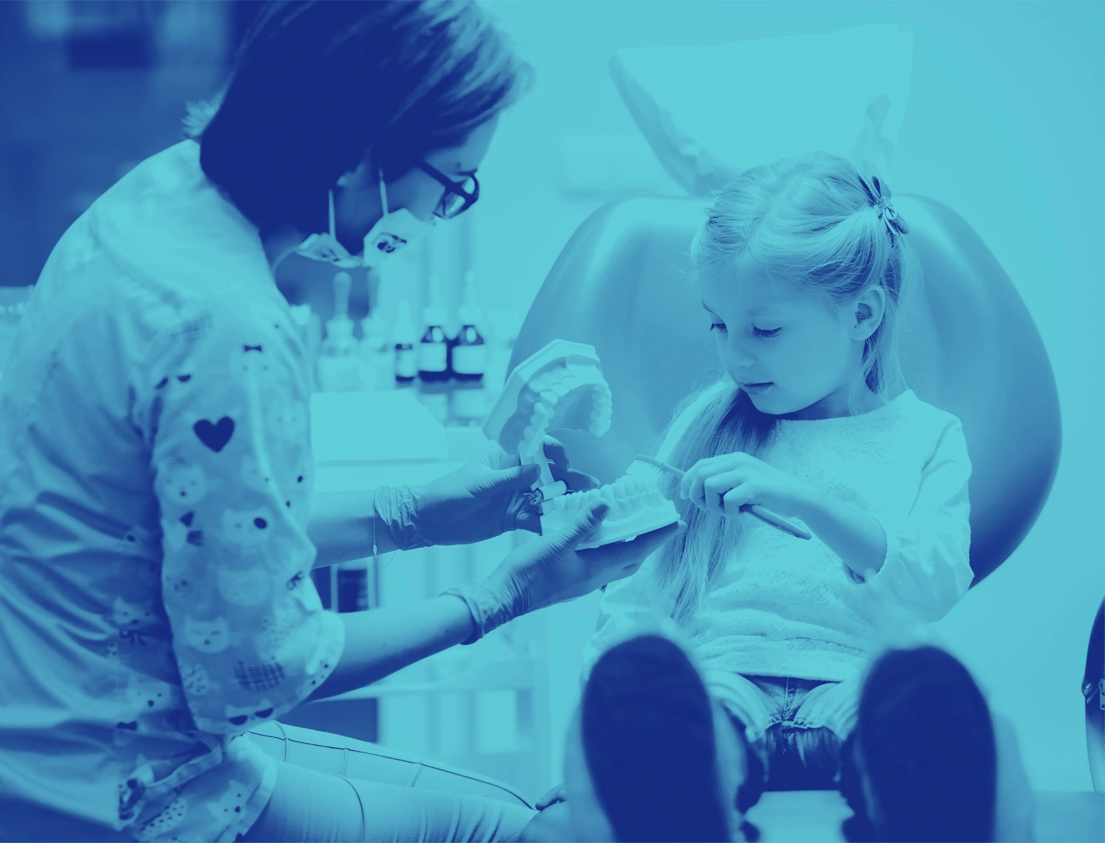 Blue duotone photo of a dentist treating a young child, used in the Ultimate Smile brand