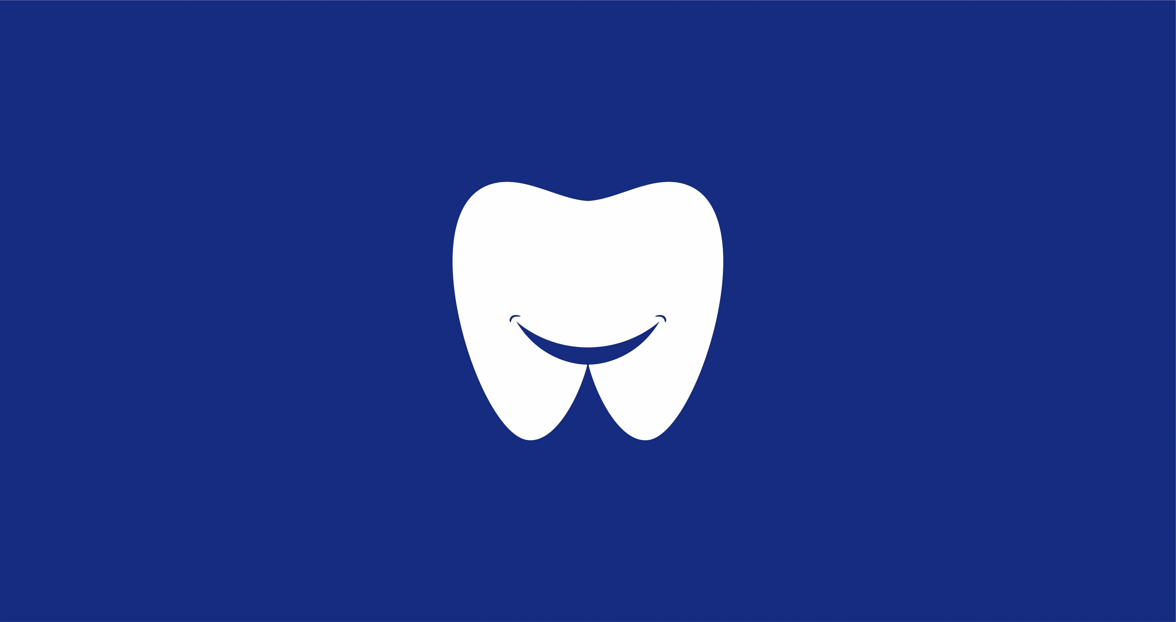 White tooth-and-smile icon on a navy background